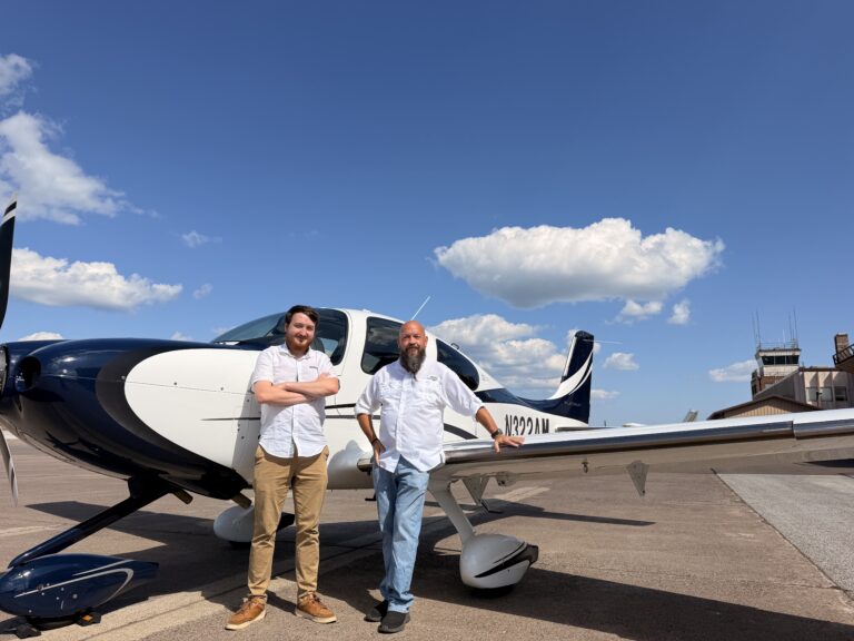 Jon and Travis Dauplaise of DAS Aviation Services leaning against a plane